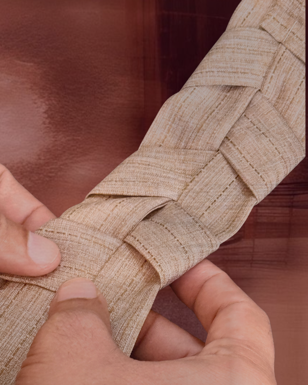 Bint Saeed—Khous braid integrated into garment structure; Emirati palm-frond weaving referenced in contemporary luxury abaya design, Abu Dhabi